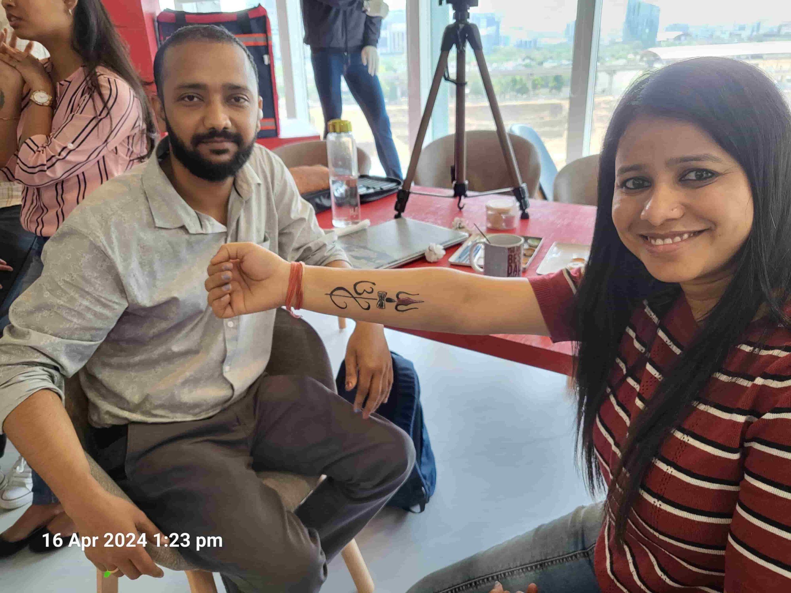 Woman showing a custom spiritual symbol tattoo on her forearm after the appointment