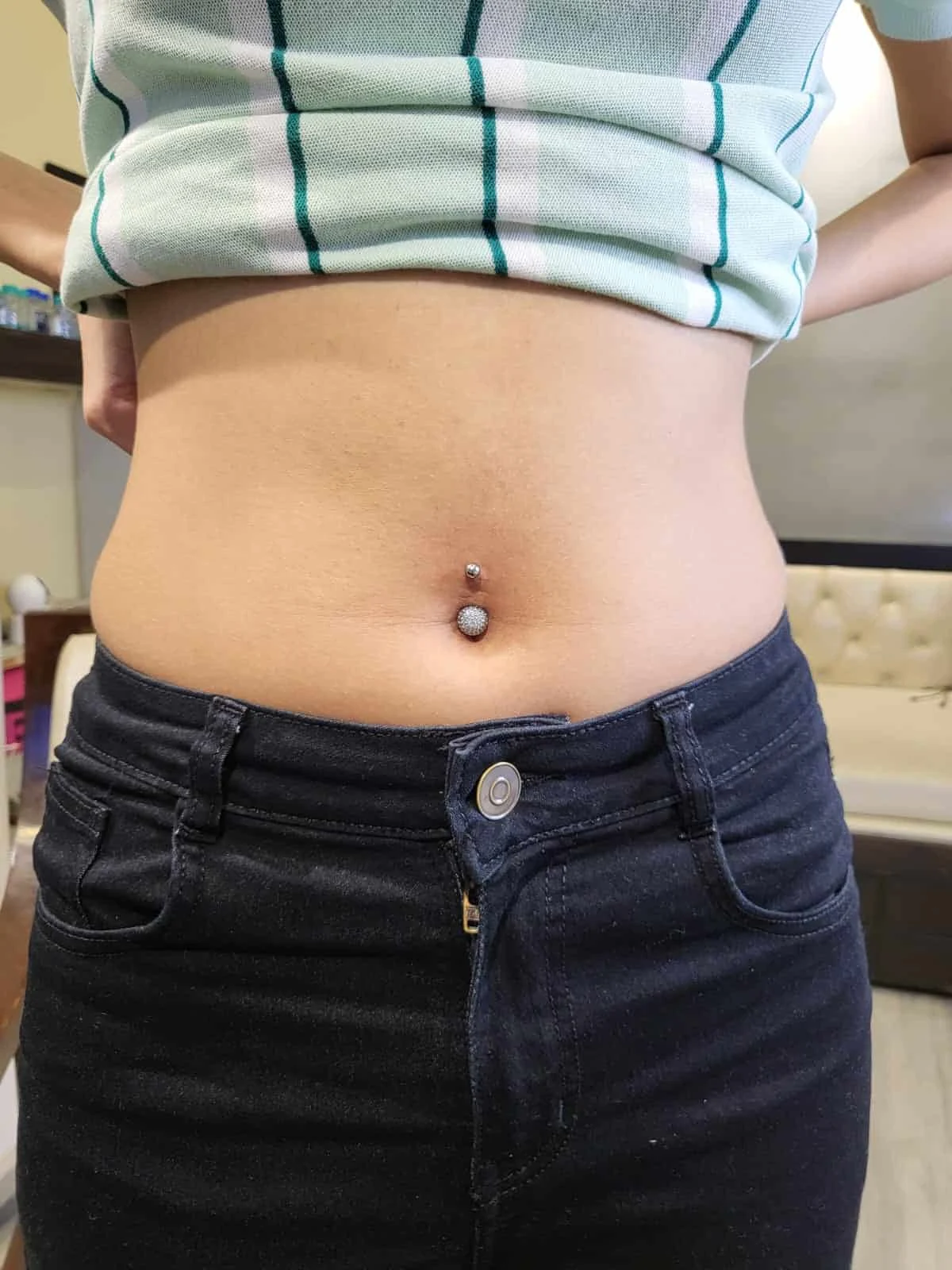 Navel piercing with decorative belly button jewellery in Palam, Delhi