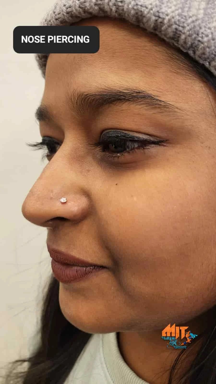 Woman wearing a nose stud after nose piercing in Palam, Delhi